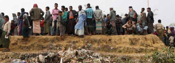Rohingya refugees at Balukhali Camp wait in line for daily essentials distribution