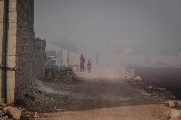 Woman and child in a desolate Syrian landscape