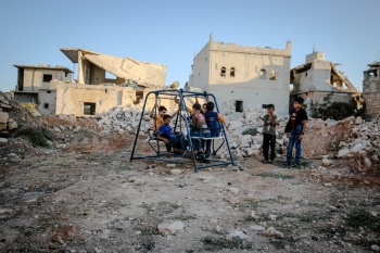 Poor children playing in city ruins