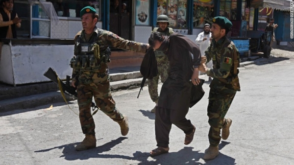 Afghan soldiers capture a suspect after Wednesday's attack on a TV station in Jalalabad, Afghanistan.