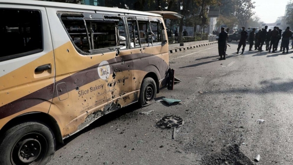 Police officers stand guard after rockets hit Kabul
