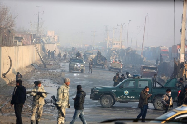 Afghan security forces gather around a compound in Kabul, Afghanistan on Tuesday Jan. 15, 2019, a day after the area experienced a suicide attack 