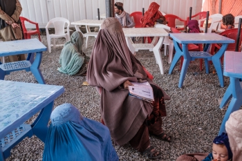 An Afghan woman waiting at a checkpoint