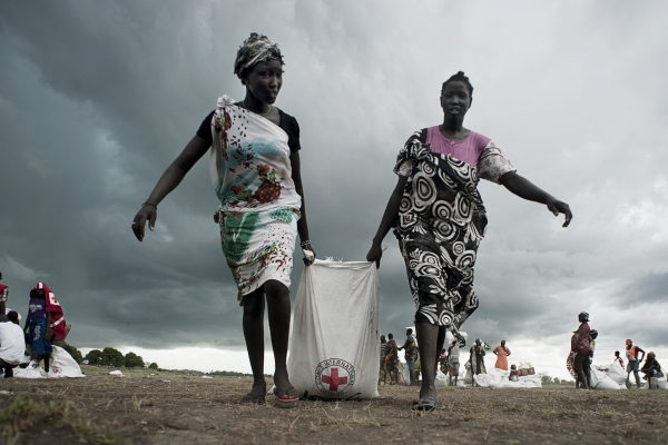 Two South Sudanese women receiving aid for the Red Cross