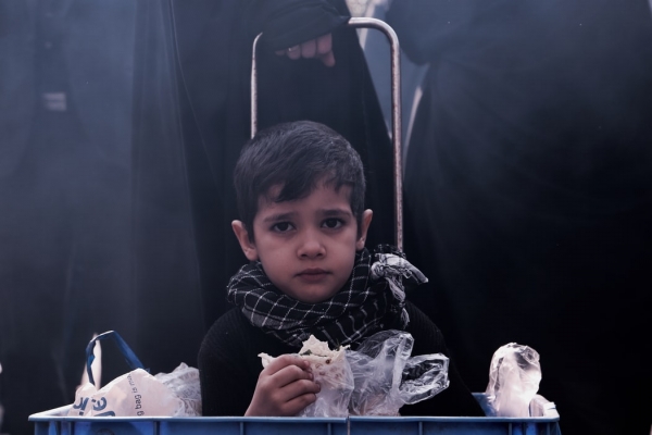  Worried boy carried in a blue basket