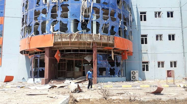 A man walks in front of a destroyed hospital in the city of Fallujah, Iraq 