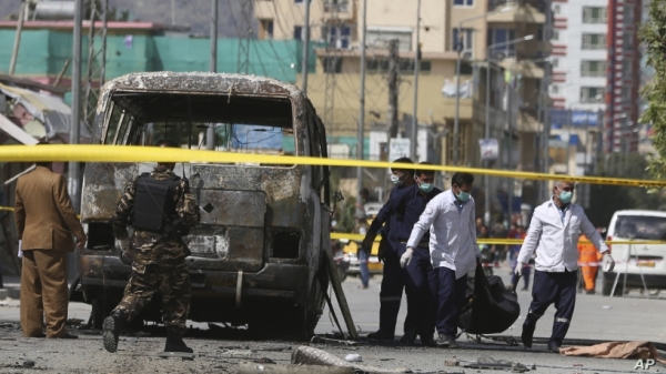 Responding doctors take a victim&rsquo;s body out of the bus that exploded in Kabul, Afghanistan