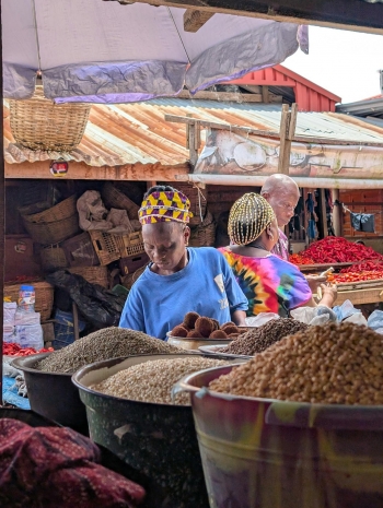 People at a local market with different spices in Nigeria.