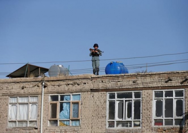  An Afghan policeman keeps watch near the site of a suicide attack in Kabul, Afghanistan September 5, 2016. 