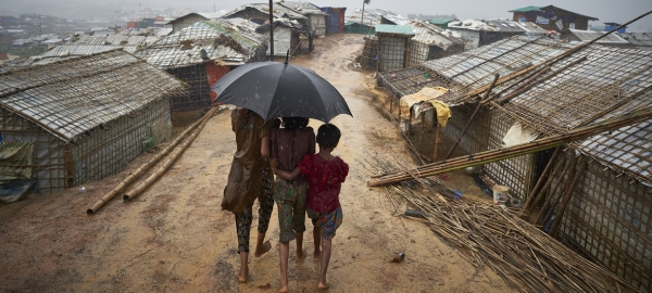  Rohingya refugees from Myanmar stand together during a downpour in Kutupalong refugee settlement, Bangladesh.