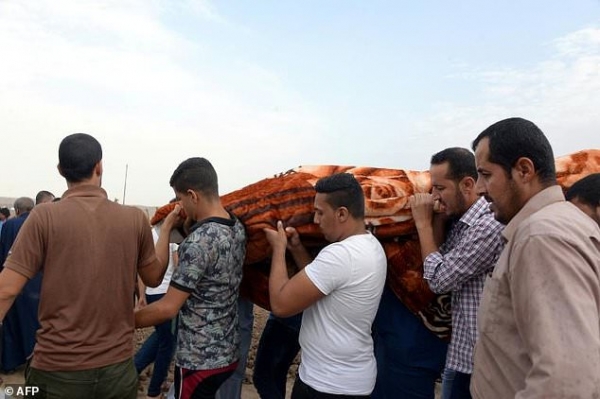 Iraqi people at a funeral of a man killed in the car bomb attack in Al Qayyarah.