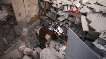 Un membro della Difesa Civile Siriana va alla ricerca di sopravvissuti tra le macerie di un ospedale a Darat Izza, 30 chilometri a nord-ovest di Aleppo 