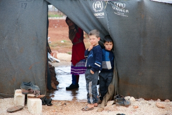 A group of young boys standing next to each other