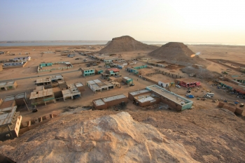 Vista aerea di una citt&agrave; nel deserto con una montagna sullo sfondo