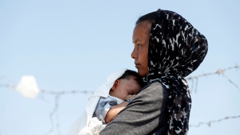 An Afghan woman and her child in a refugee camp in Lesvos, Greece