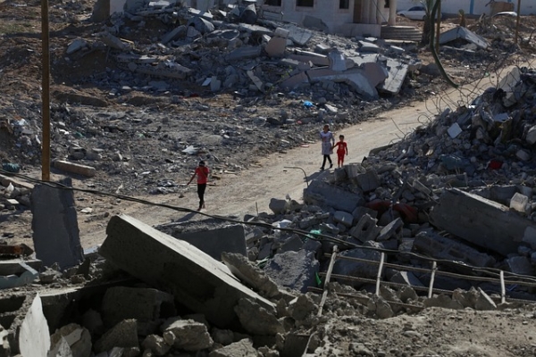 Children walking among ruins of bombarded houses, Gaza