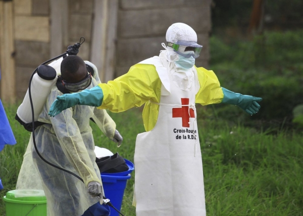  A health worker disinfects a colleague in Beni, North Kivu Province at an Ebola treatment center