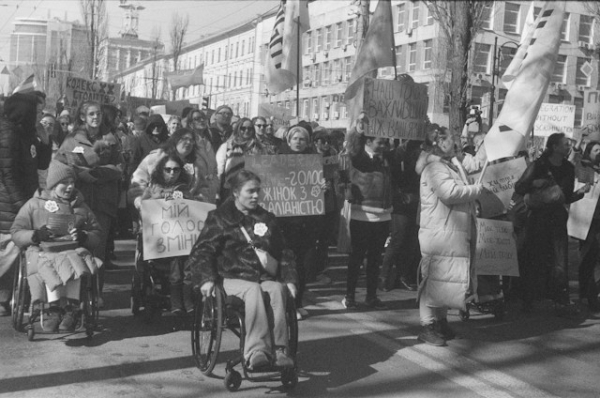 Disabled individuals participating in the socio-political life of their community by protesting on the streets