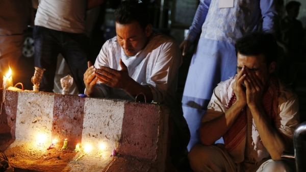 Afghans pray for the victims of a suicide bomb blast during a memorial in Kabul 
