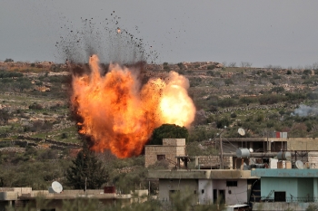 Fire pours out after an airstrike hit a building in the Idlib province 