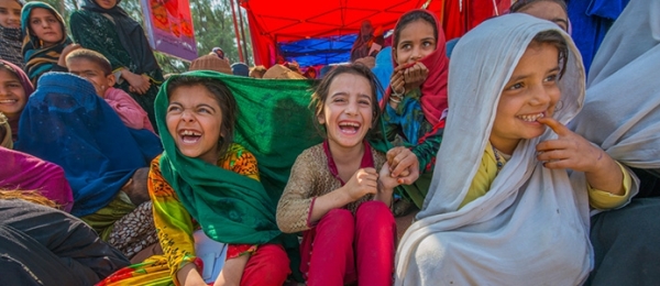 Children wait outside a health clinic in rural Afghanistan 