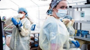 Health workers putting protective gear before the beginning of the shift