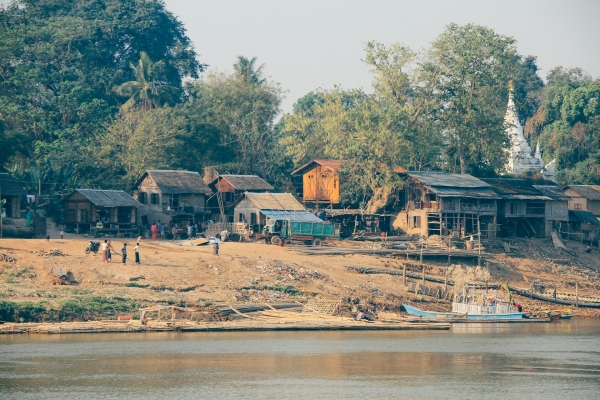 Rohingya people standing near their house