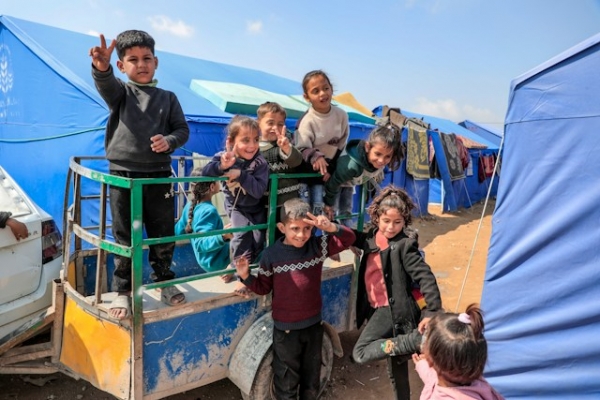 Children smiling in a refugee camp