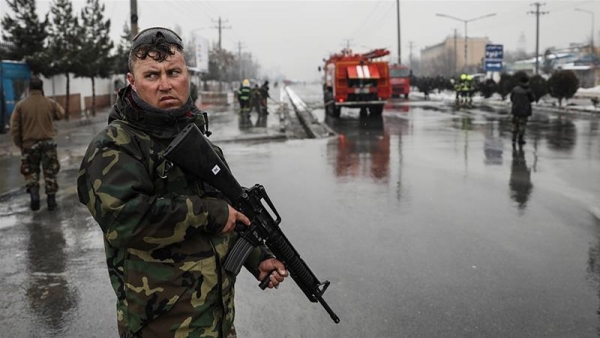Afghan security forces stand watch by the site of a suicide bombing in Kabul, Afghanistan 