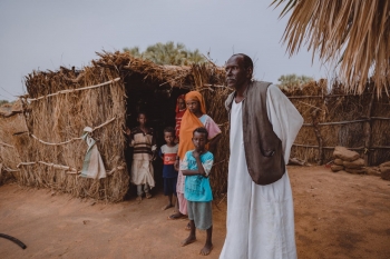 Family in front of their house in a village in Sudan