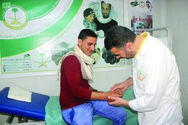 Health worker examines a Syrian refugee in Zaatari refugee camp, Jordan: