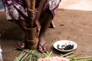 Woman grinding coffee beans in Ethiopia