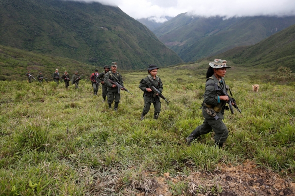 A group of guerrilleros walking through the Colombian mountains