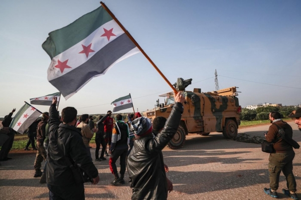Syrian protests in front of a Turkish military vehicle 