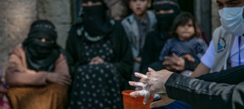 A woman washes her hands in Yemen