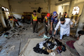 Rescue workers in the mosque after the blast, Peshawar, Pakistan