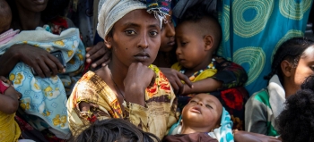 A woman with her child waits amongst many others to be seen at a clinic in Southern Tigray.