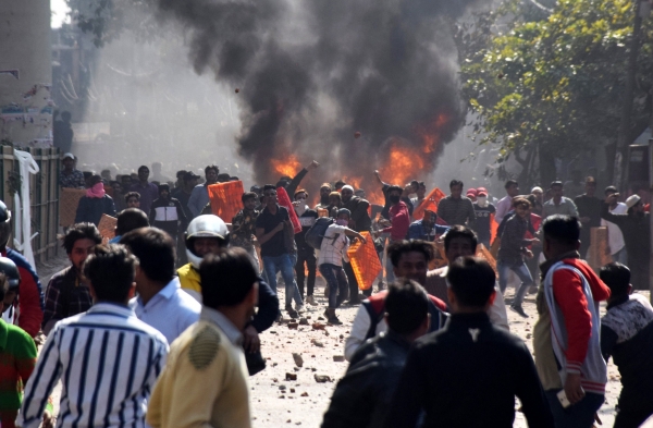 Smoke rises from a clash in Delhi where Hindus supporting a new citizenship law faced off against Muslims opposed to it. 