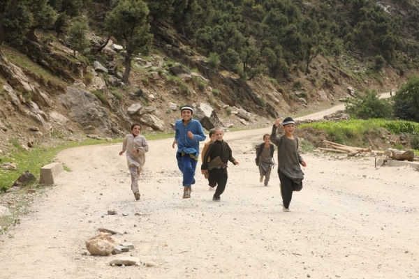 Children running through a desolated path 
