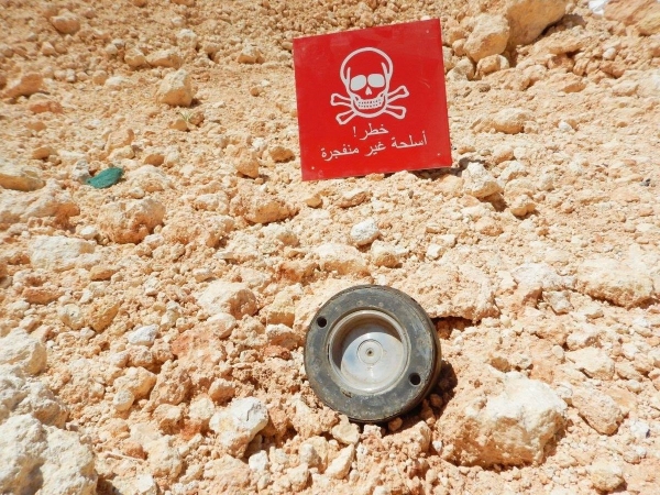 A warning sign placed next to unexploded ordnance in Syria