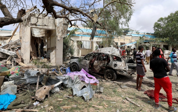 Civilians stand near the scene of explosion in Hodan District, Mogadishu