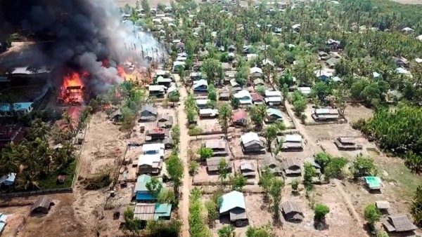 A fire burns in a village in the Rakhine State of Myanmar 