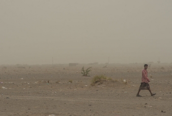 A young man walks across the desert wasteland near al Khocha district on Yemen’s western coast, near the frontline. 
