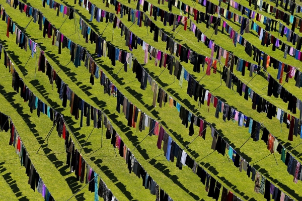 The art installation “Thinking of you” by Kosovan artist Alketa Xhafa- Mripa displays thousands of clothes spread out in the sun inside the stadium of Pristina to show the extension of the use of rape as weapon of war during the conflict in the Former Republic of Yugoslavia.