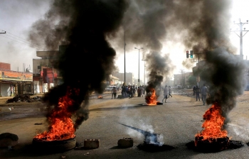 Protesters create a burning barricade in Khartoum, Sudan so that the Military Council will hand over power to civilians. 