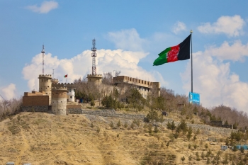 The Afghan flag waves close to a castle