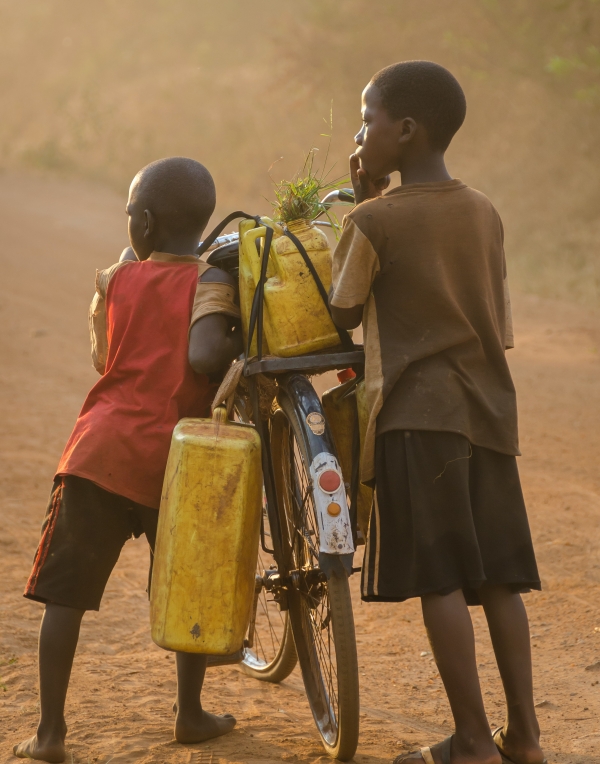 Two children carrying water