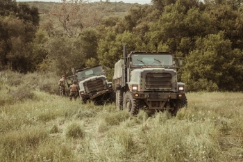 Military trucks moving in a moorland