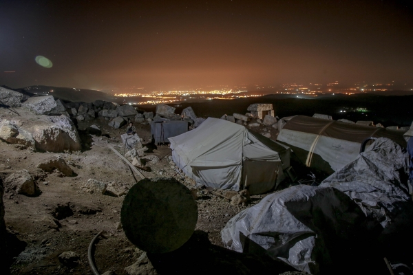 Tents for homeless people in stony terrain in Idlib, Syria