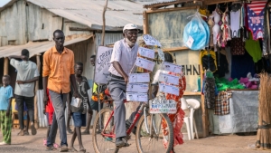 Djuba Alois, a 75-year-old pastor, preaches on his bicycle during COVID-19 pandemic in Kakuma refugee camp (Kenya).
